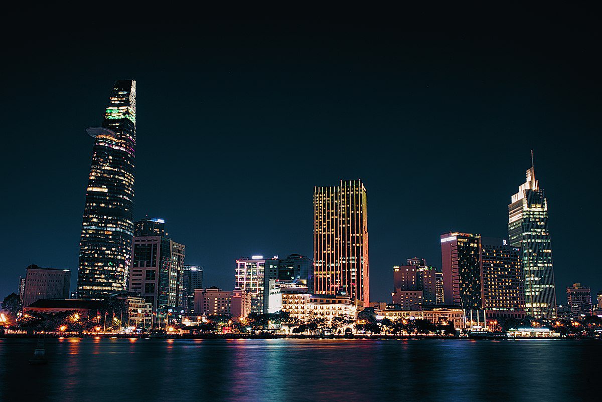 Ho Chi Minh City skyline at night across the Saigon River, the old District 1 now split into new wards