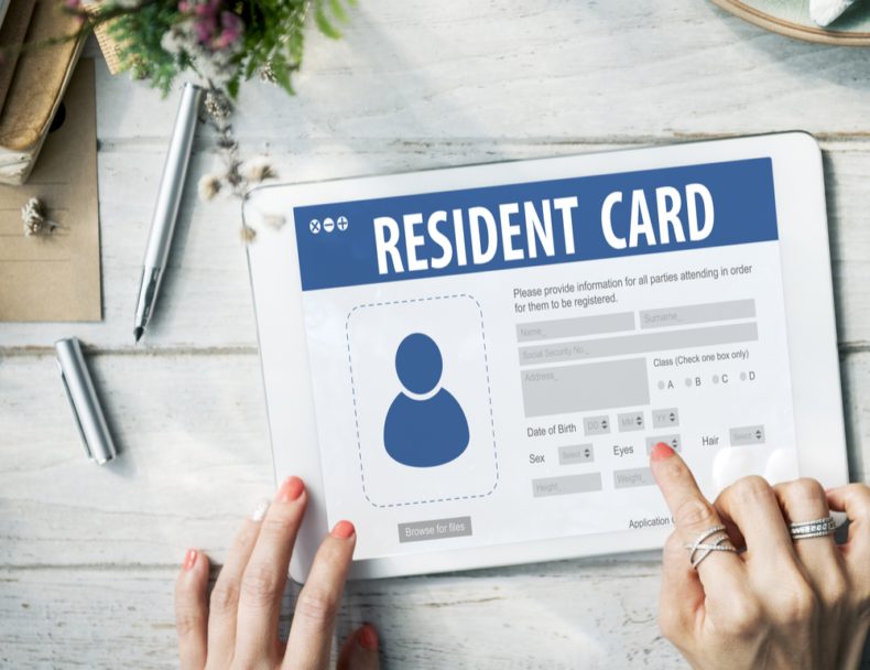 Tablet screen showing a resident card application form with photo and personal detail fields