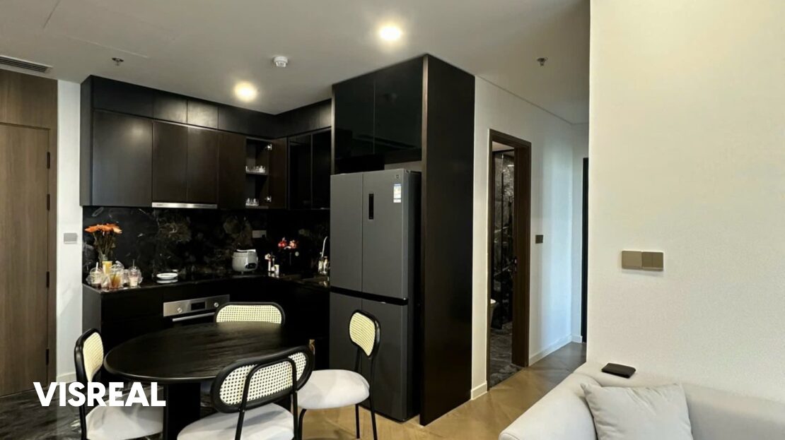Black round dining table and kitchen with four-door fridge, Lumiere Riverside apartment