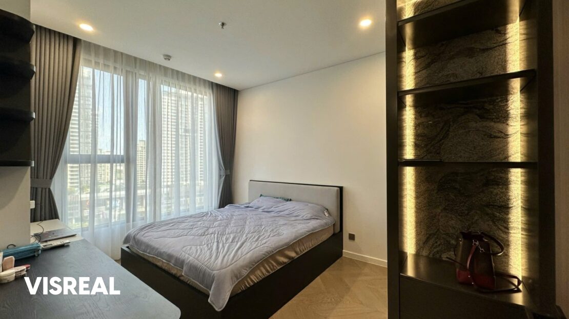 Main bedroom with lit stone-backed shelving unit, Lumiere Riverside 2BR rental