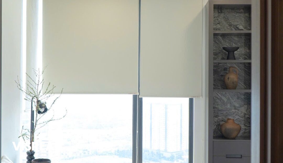Bedroom with roller blinds and stone-backed shelving, Lumiere Riverside apartment