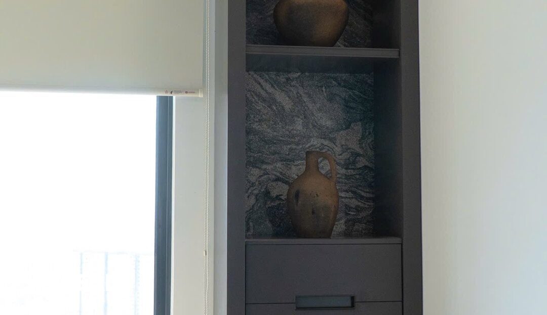 Built-in shelving unit with ceramic vases, bedroom of a Lumiere Riverside 2BR