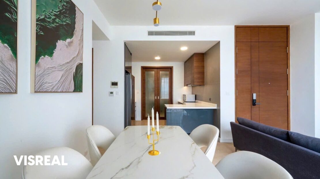 Dining area looking toward walnut kitchen and entrance door, The Nassim apartment for rent
