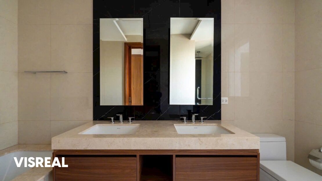 Double vanity with walnut cabinet and black marble wall, bathroom in The Nassim apartment