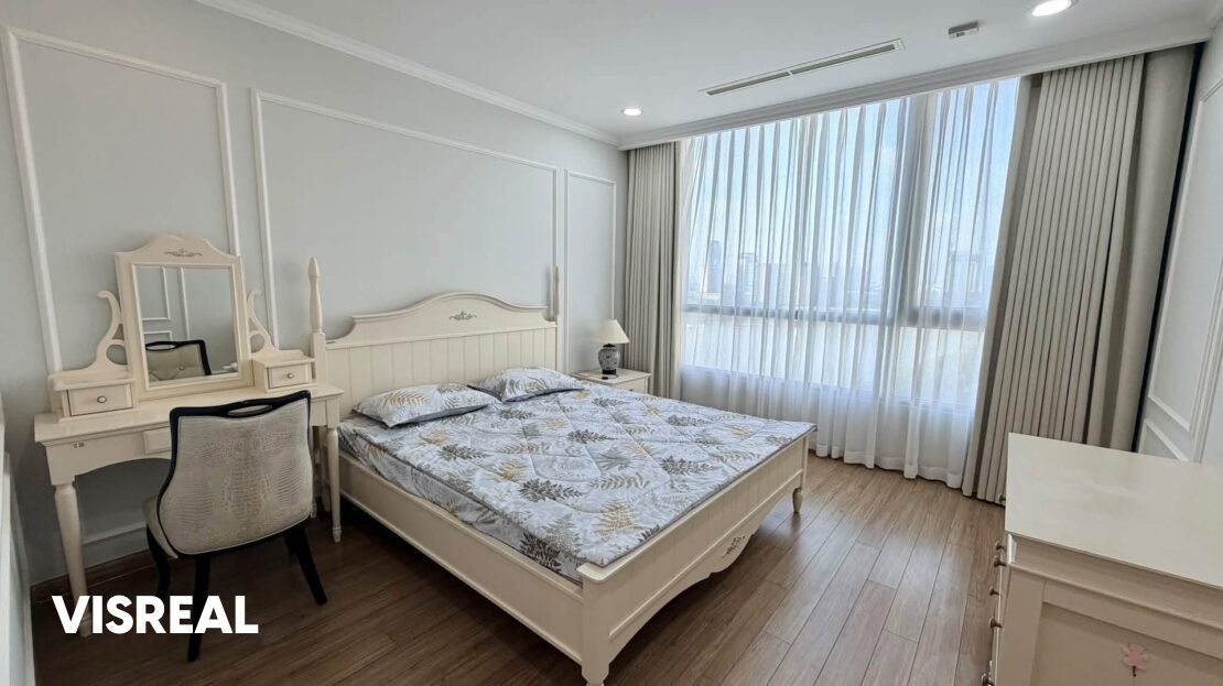 Master bedroom with cream classic bed and dressing table, Vinhomes Central Park 3-bedroom