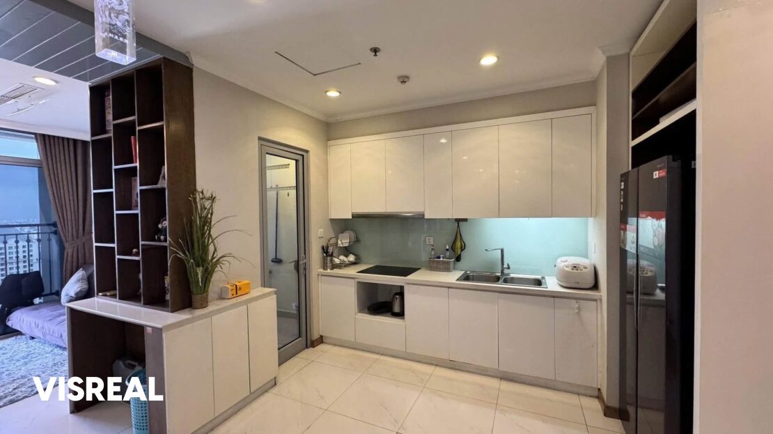 Kitchen with induction hob, double sink and black side-by-side fridge, Vinhomes Central Park 2BR