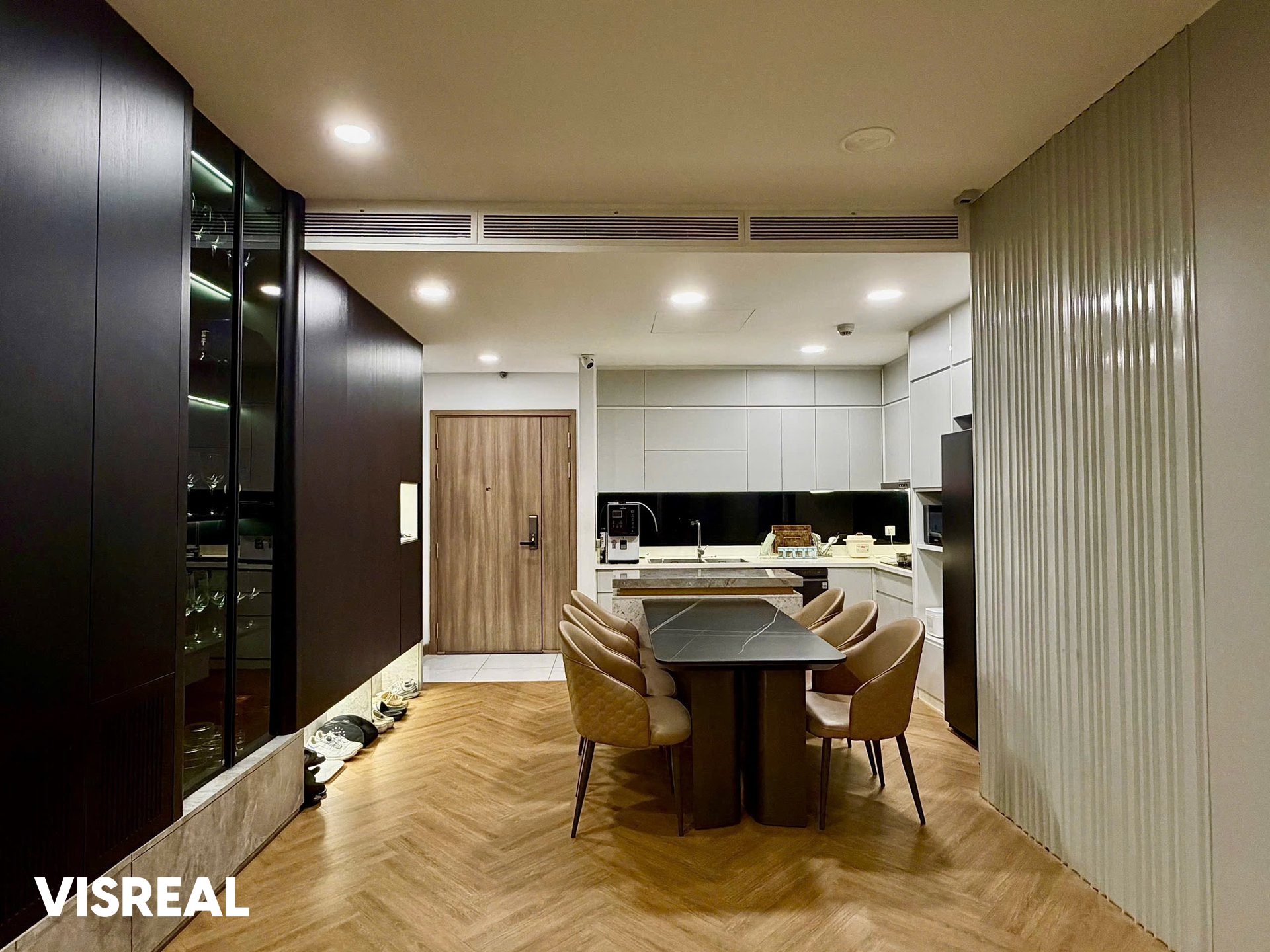 Entrance with digital door lock, dining table and kitchen in a 2-bedroom apartment at Sunwah Pearl, Binh Thanh
