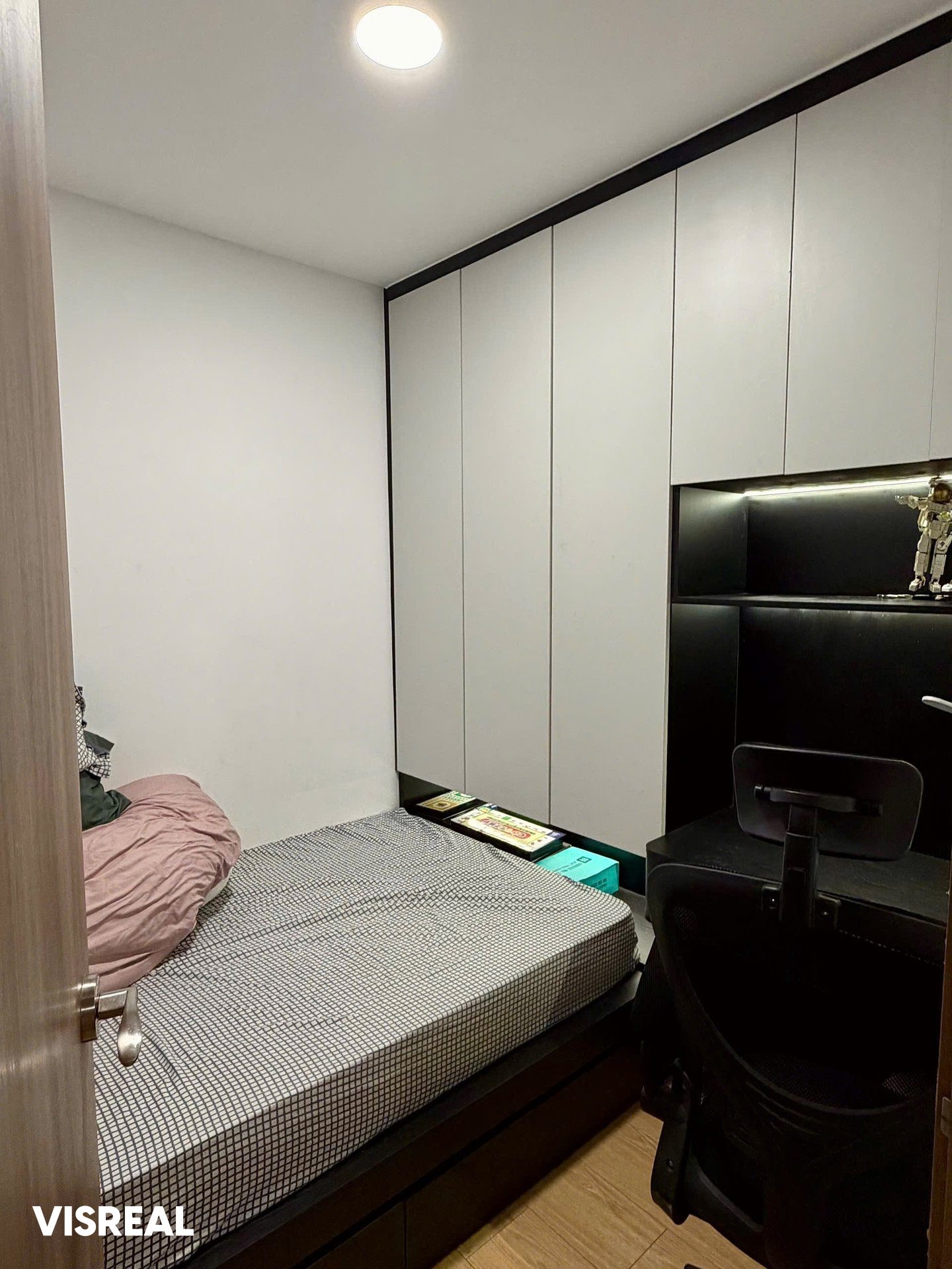 Small second bedroom with a single bed, desk and full-height cupboards in a 2-bedroom apartment at Sunwah Pearl