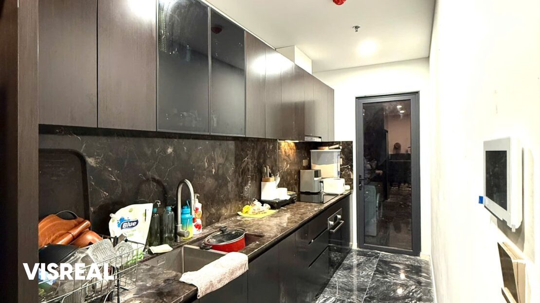 Galley kitchen with stone worktop and glass-front cabinets, Lumiere Riverside apartment