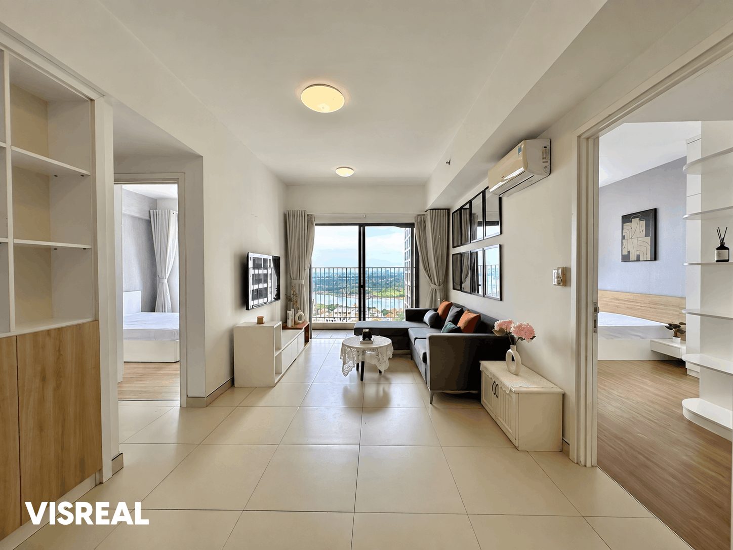 Living room of a 2-bedroom apartment at Masteri Thao Dien with a balcony view over the Saigon River